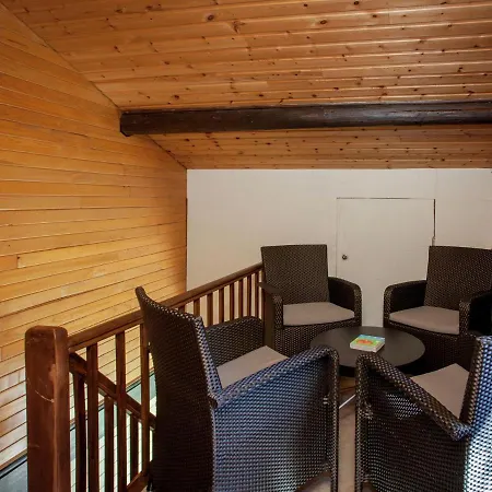 Open Wooden Chalet Built Against A Hill *